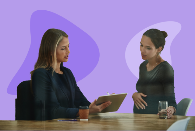 Pregnant employee with water discusses protected leave with her supervisor.